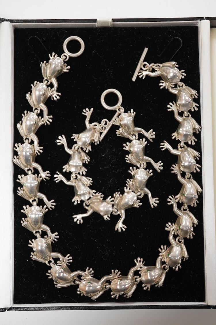 A recent white metal frog necklace, overall length 42cm and matching bracelet, 19cm, both stamped 925, gross 153 grams.